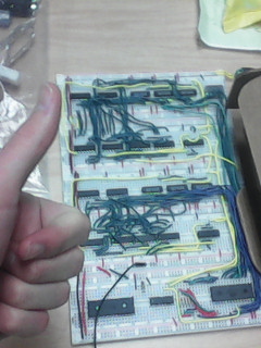 The assembled card on breadboards with my making a thumbsup