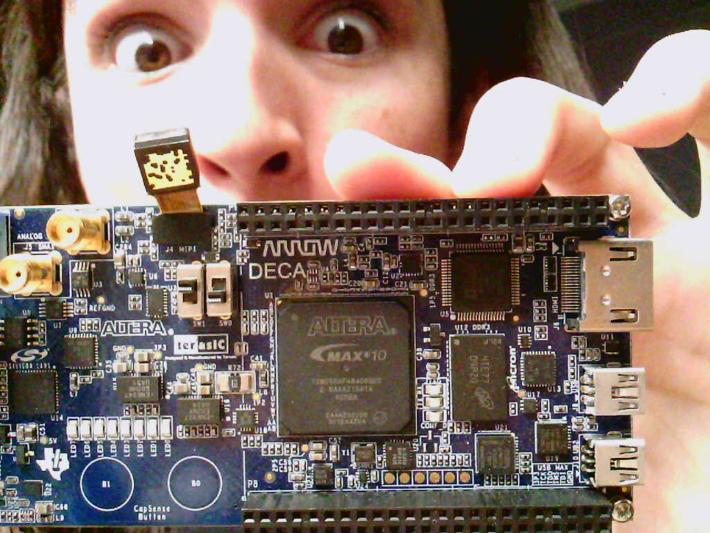 jacob holding the Terasic DECA FPGA dev board in front of his face with his eyes still visible over the top